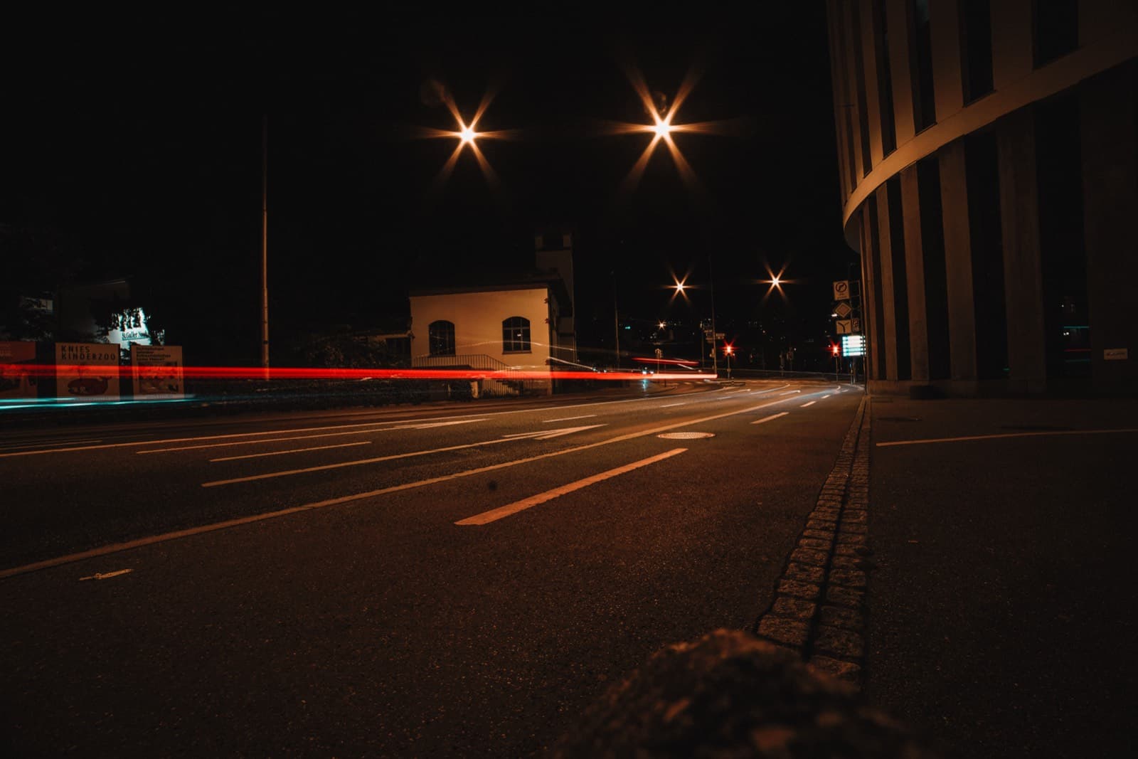 Nighttime urban street with red and blue vehicle light trails